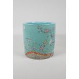 A Chinese polychrome porcelain brush pot decorated with birds amongst flowers, seal mark to base,