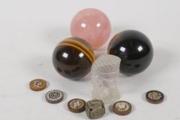 Two "Tigers eye" and one rose quartz crystal ball, largest 2" diameter. Together with a moulded