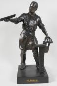 A bronze figure of a metal worker, 16" high