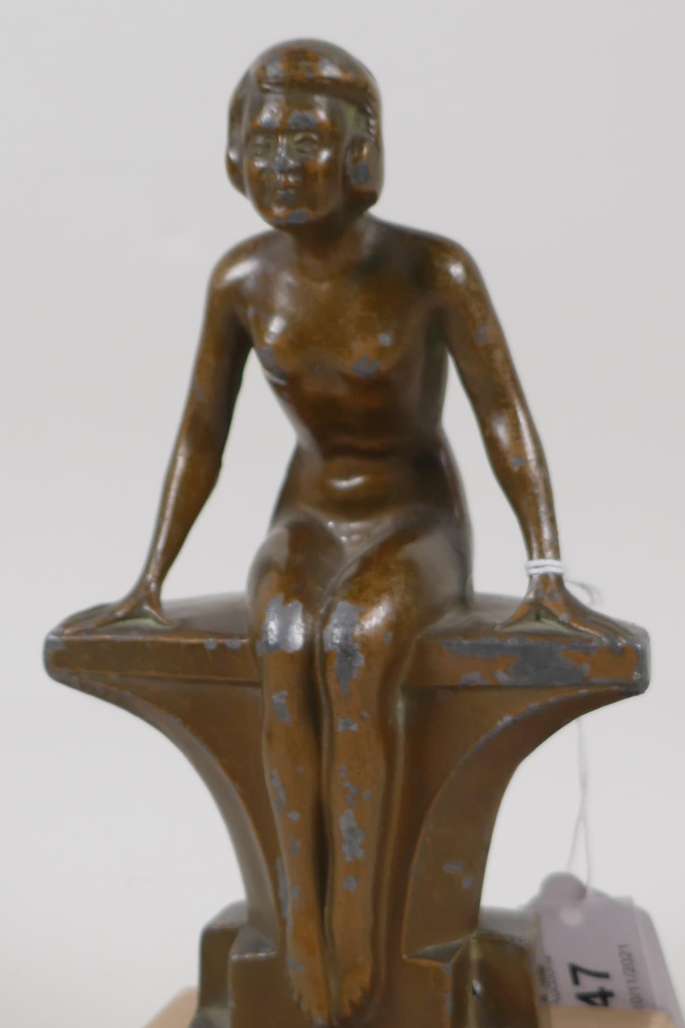 An Art Deco bronzed spelter figurine of a nude girl seated on a bench, 7½" high - Image 2 of 3