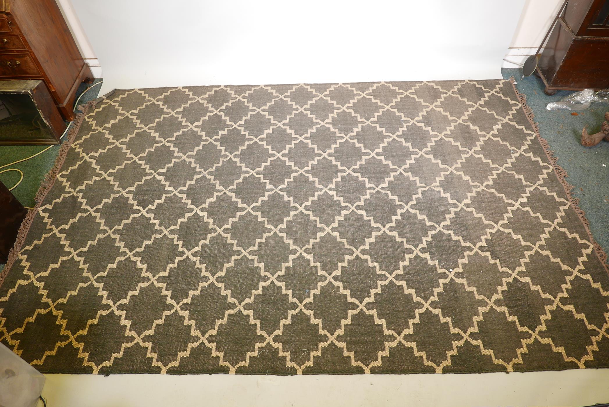 A black ground woven wool carpet, with a natural coloured repeating geometric pattern. 74" x 110" - Image 2 of 4