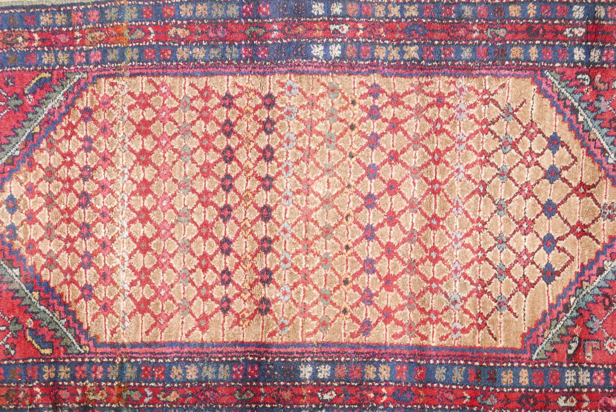An antique, deep pile, hand woven wool Persian rug. With geometric designs in a central panel & blue - Image 2 of 5