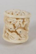 A carved bone Netsuke of cylindrical form, carved with birds. 1¼" long