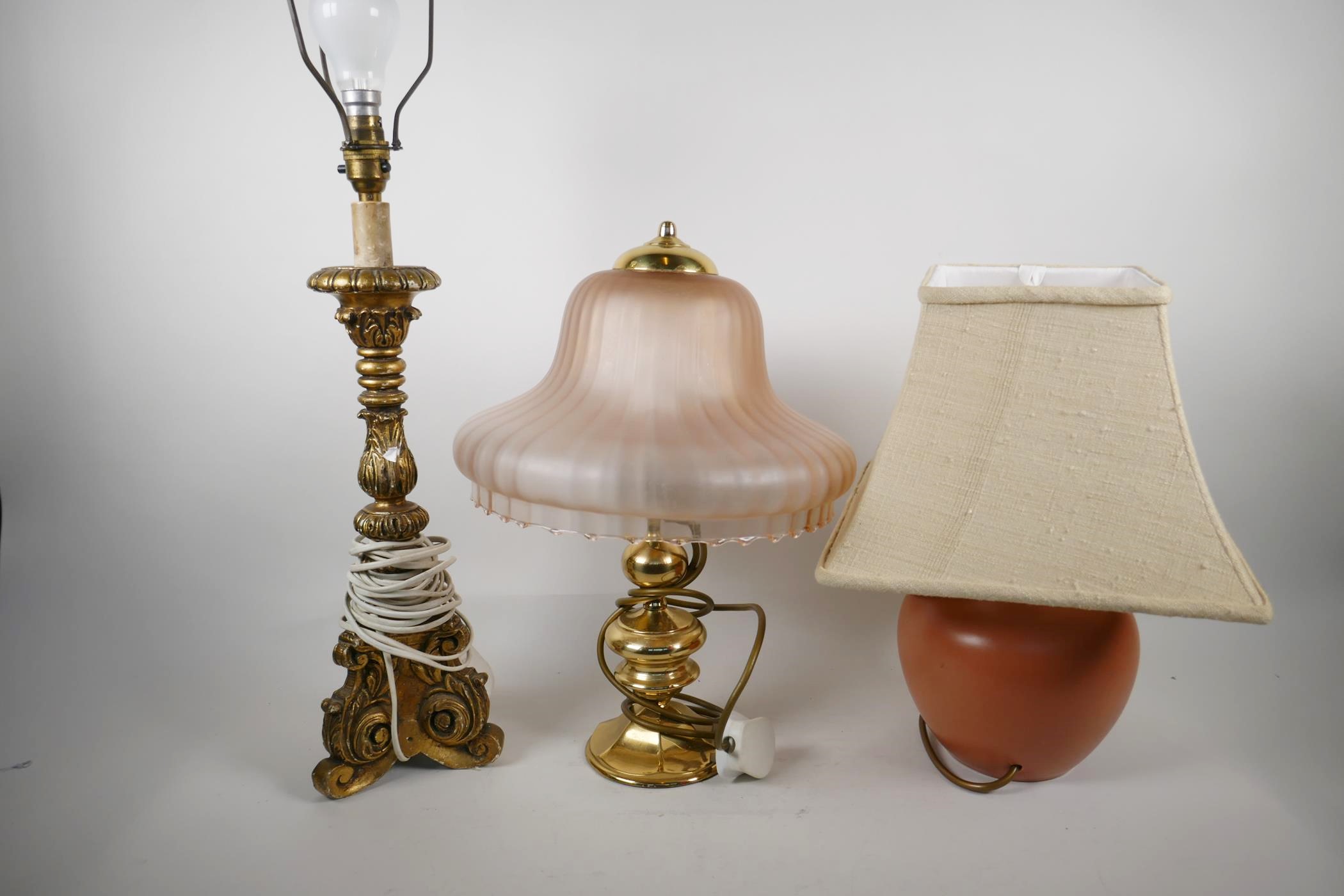 A brass table lamp with pink frosted glass shade, 16" high and two other lamps