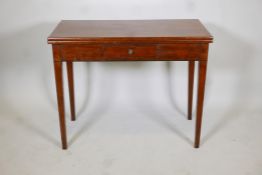 A Georgian III mark tea table with a fold over top and a single drawer, raised on square tapering