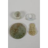 A Chinese celadon jade ring and another smaller, with a green jade buddha pendant and a jade pi