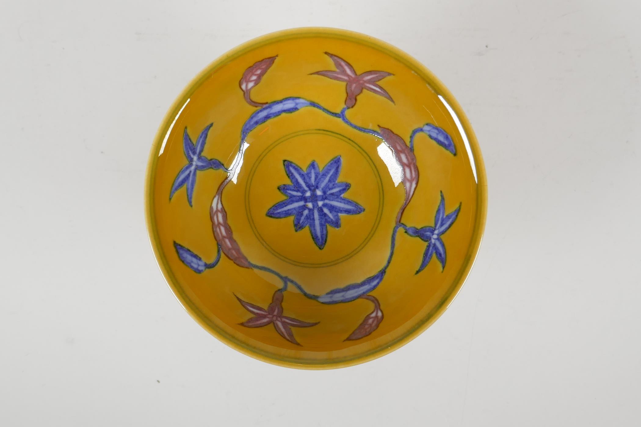 A Chinese yellow ground porcelain stem bowl with red and blue floral decoration, 6 character mark to - Image 2 of 4