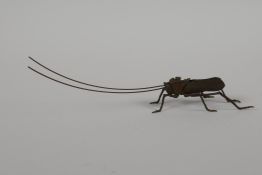 A Japanese Jizai style bronze of a grasshopper, with articulated limbs & antennae, 6" long