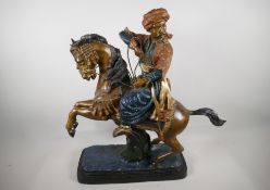 A large gold painted brass figure of an Arab tribesman, riding a horse, 24" high