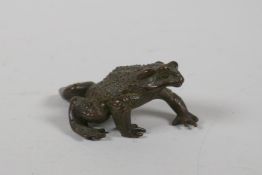 A Japanese bronze okimono in the form of a toad, indistinct impressed mark to base, 3" long
