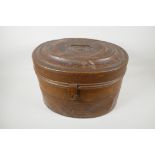 A C19th oval metal hat box, 16" wide