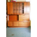 A White & Newton 'Chichester' teak high board, the upper section with bi-fold cupboard doors, and