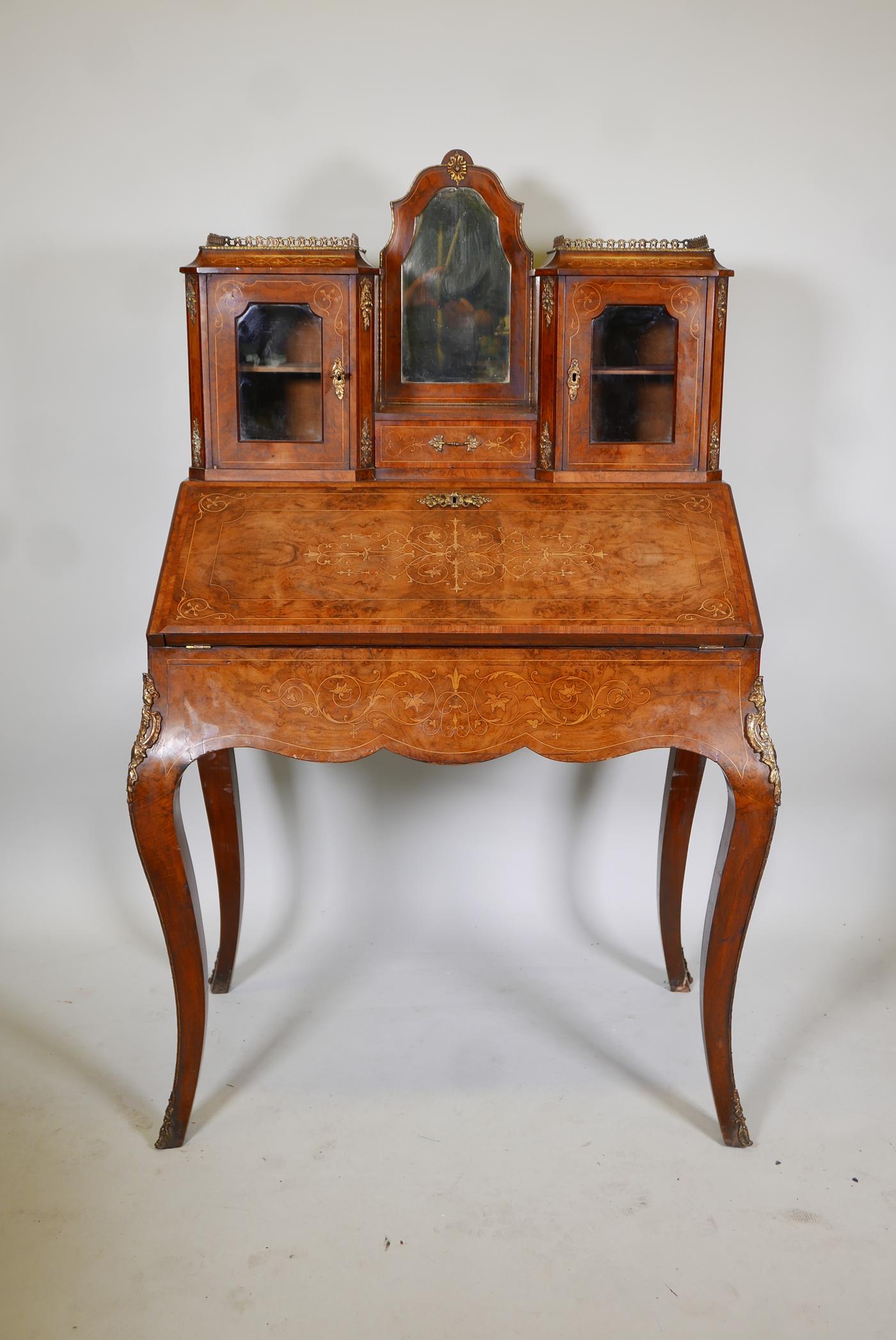 A Victorian inlaid, figured and burr walnut bonne-heure-de jour, with a brass galleried top and