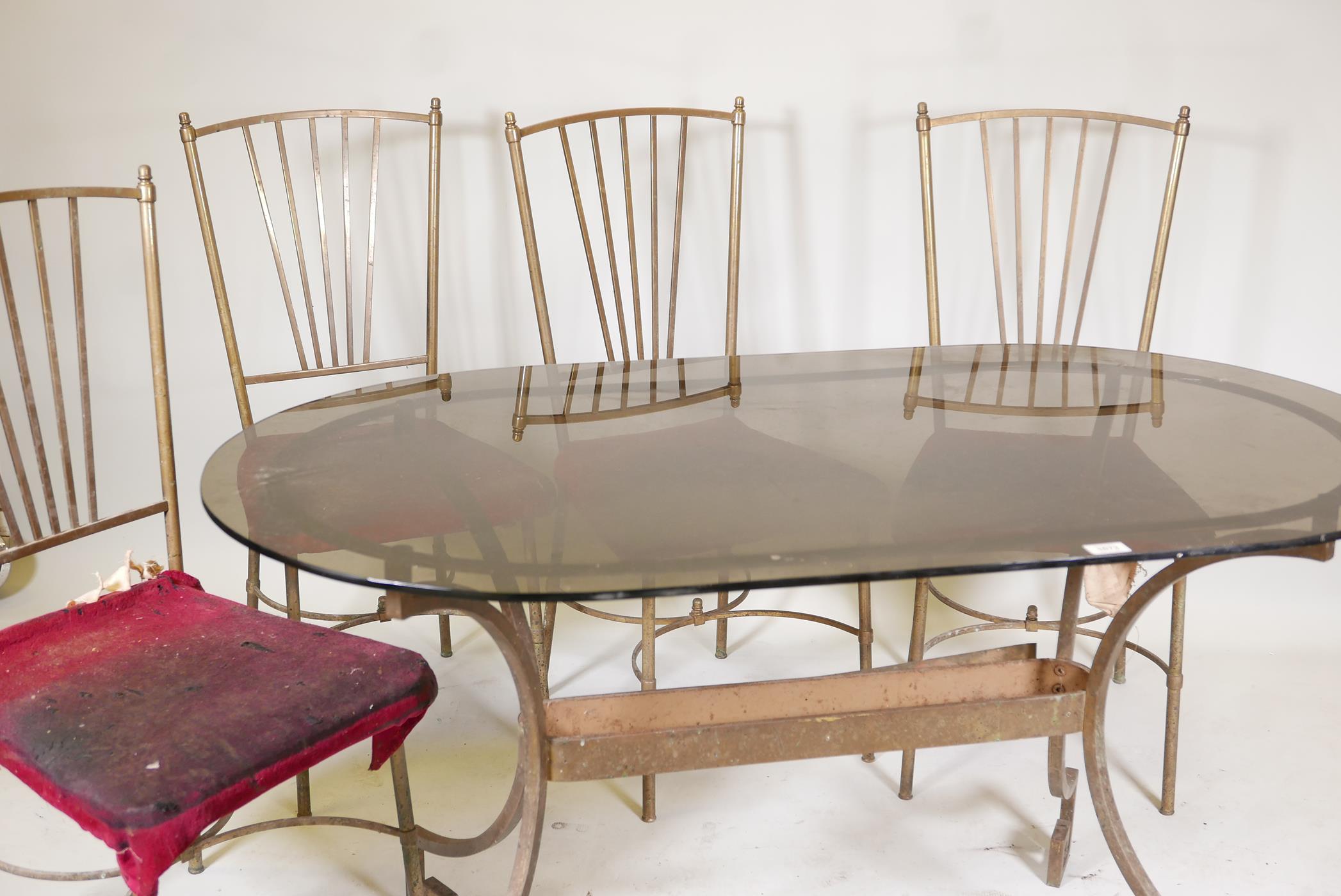 A vintage brass conservatory table, with tinted glass top & four chairs ensuite. 30" x 53"