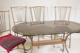A vintage brass conservatory table, with tinted glass top & four chairs ensuite. 30" x 53"