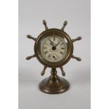 A brass cased desk clock in the form of a ships wheel, 6" high