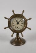 A brass cased desk clock in the form of a ships wheel, 6" high
