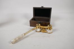 A pair of brass and mother of pearl opera glasses, in a hardwood box, 5¼" long