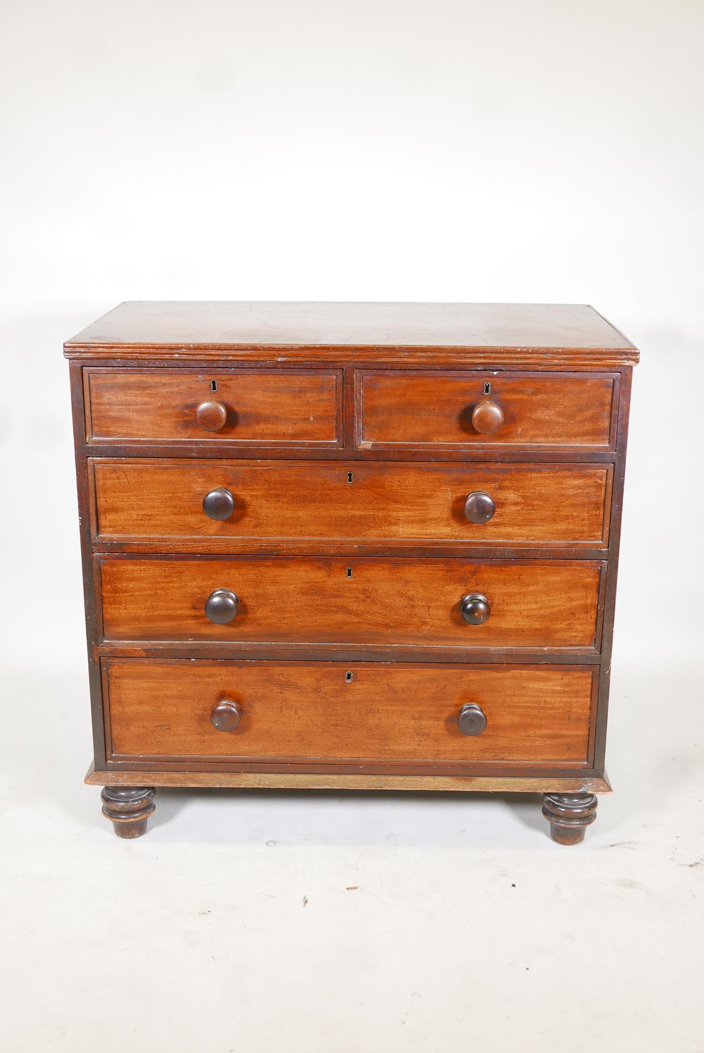 A early C19th mahogany chest, of 2 over 3 graduated drawers, raised on turned supports. 36" x 19½" x