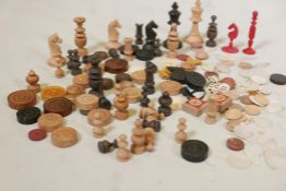 A quantity of C19th chess & chequers pieces, mother of pearl counters, etc