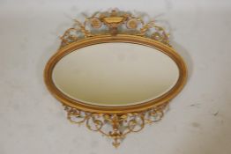 Adam style giltwood and composition wall mirror decorated with swags of harebells and scrolls and an