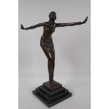 An Art Deco style figurine of a dancing girl, after Preis, on a stepped base, 16½" high