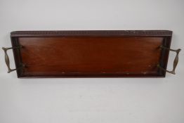 A C19th carved mahogany tray, with brass handles, 22¾" x 7½" wide