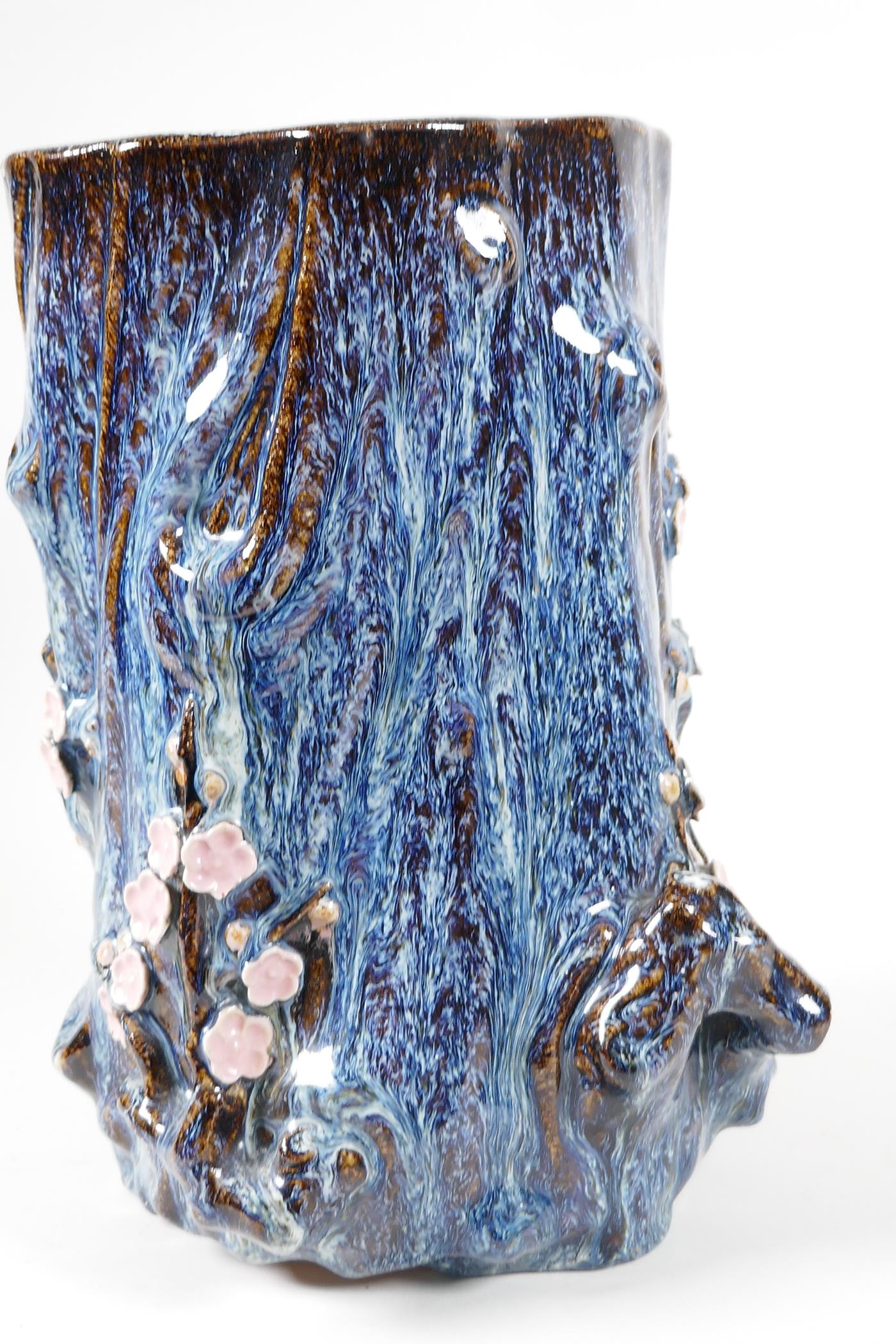 An Oriental stoneware vase, formed as a tree trunk with embossed prunus blossom, on a flambe - Image 5 of 5