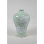 A celadon ground porcelain meiping vase with raised white enamelled floral decoration, Chinese