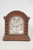 An oak cased mantle clock, with silvered dial and Arabic numerals, the German movement striking on