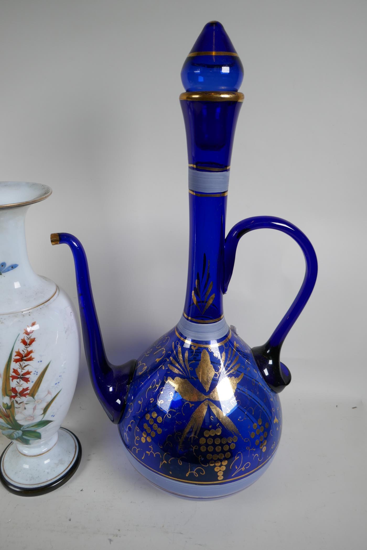 A gilt decorated blue glass wine ewer and stopper, 19" high, a milk glass vase painted with flowers, - Image 2 of 4