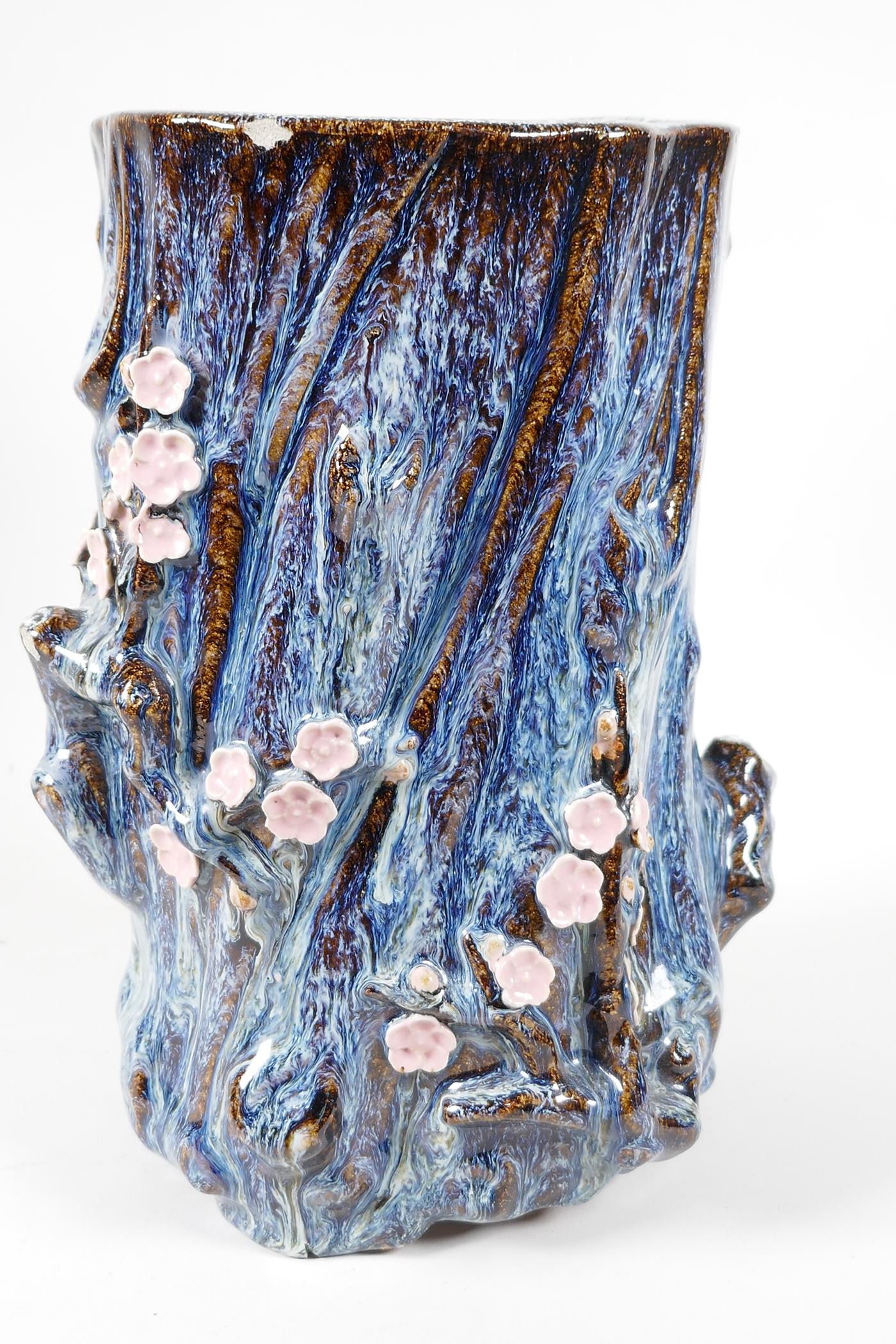 An Oriental stoneware vase, formed as a tree trunk with embossed prunus blossom, on a flambe - Image 4 of 5