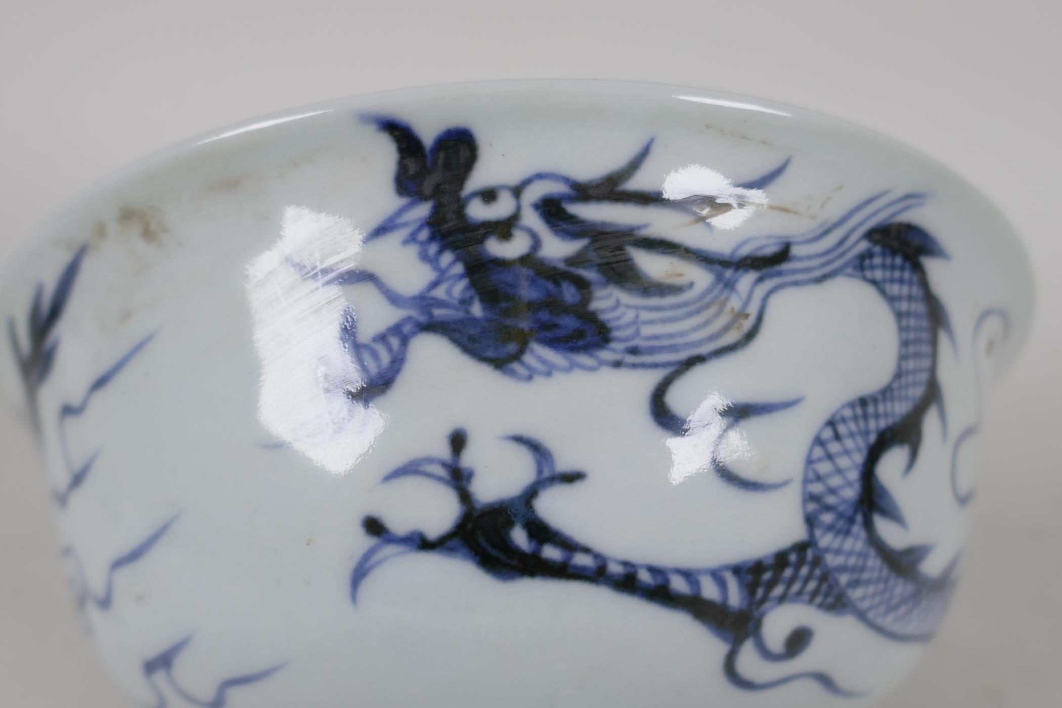 A Chinese blue & white porcelain stem cup, painted and embossed with dragons and clouds. 5" diameter - Image 3 of 5