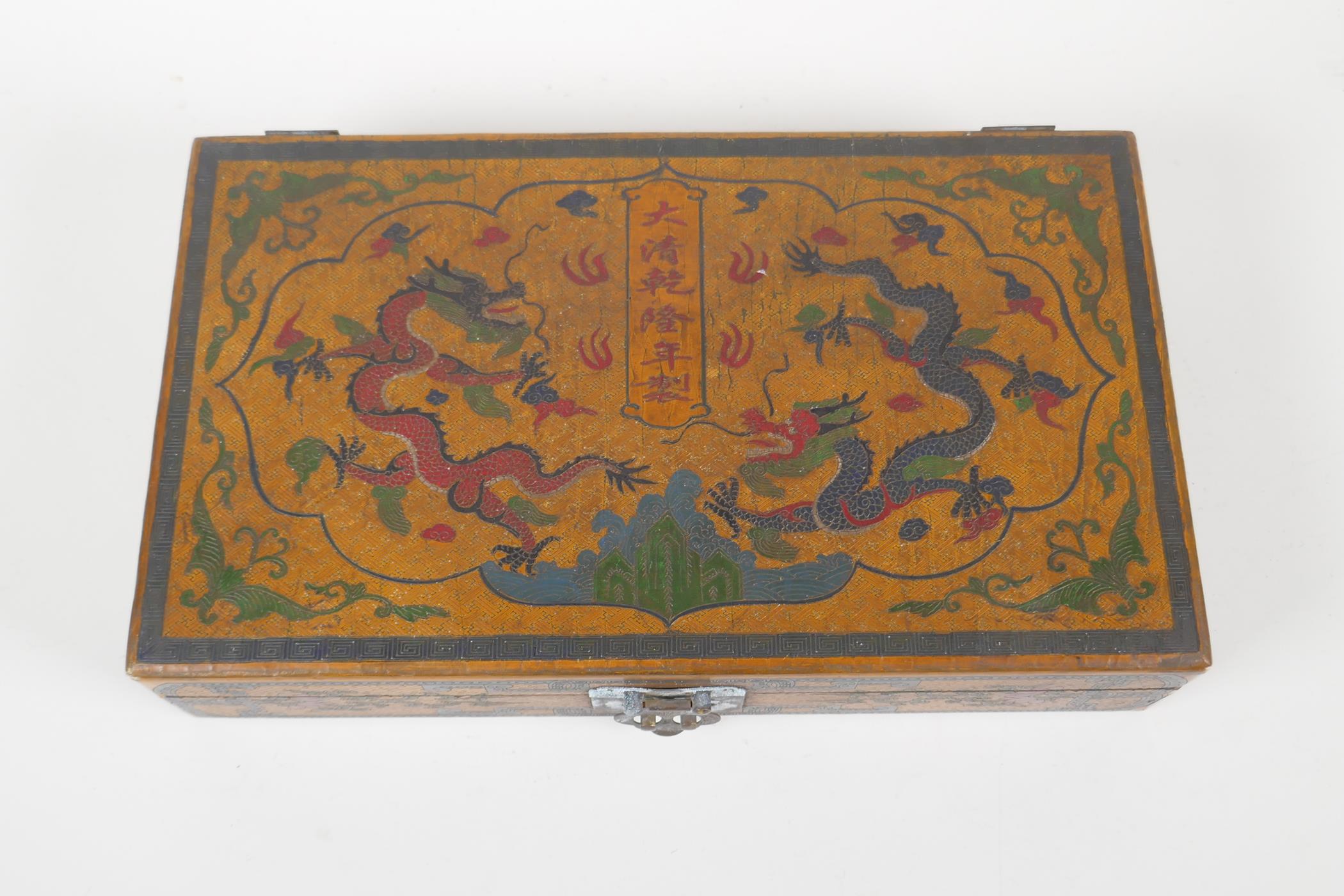 A Chinese ochre ground lacquer box with chased and painted decoration of dragons and character - Image 2 of 4