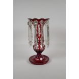 A Bohemian ruby glass lustre with flash cut decoration, 1 lustre missing, 12½" high