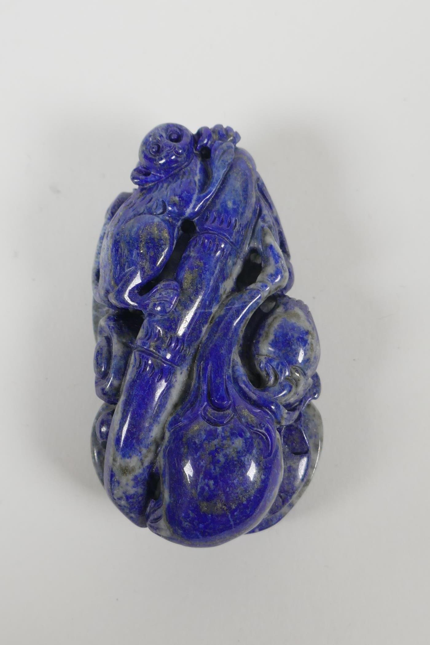 A Chinese carved lapis pendant/ornament, depicting a monkey on bamboo with gourds. 3" long