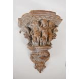 An ornately carved wood wall bracket. Carved in the form of a classical column capital. 13" long