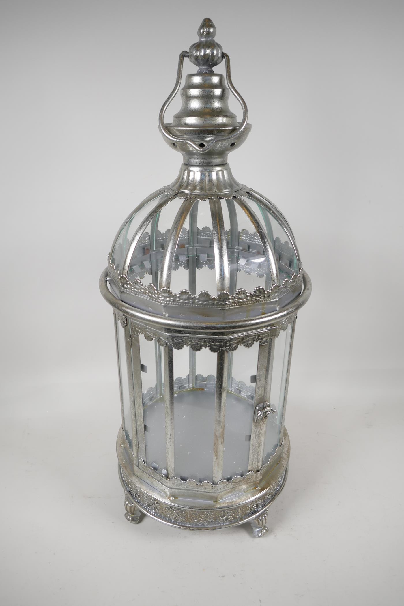 A silver plated, metal & glass cylindrical garden lantern, 24" high