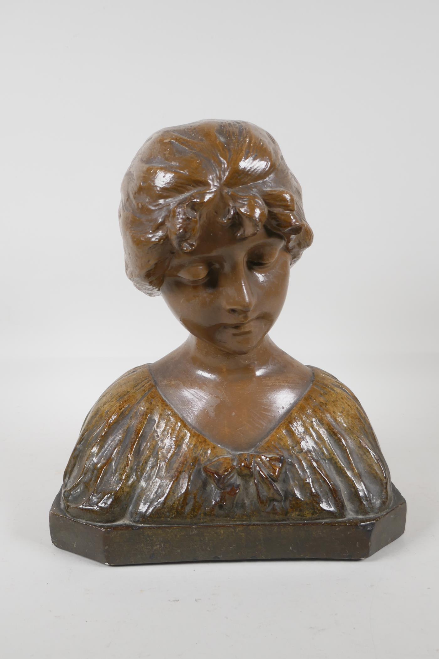 A glazed terracotta bust of a girl in a shawl. 12 high