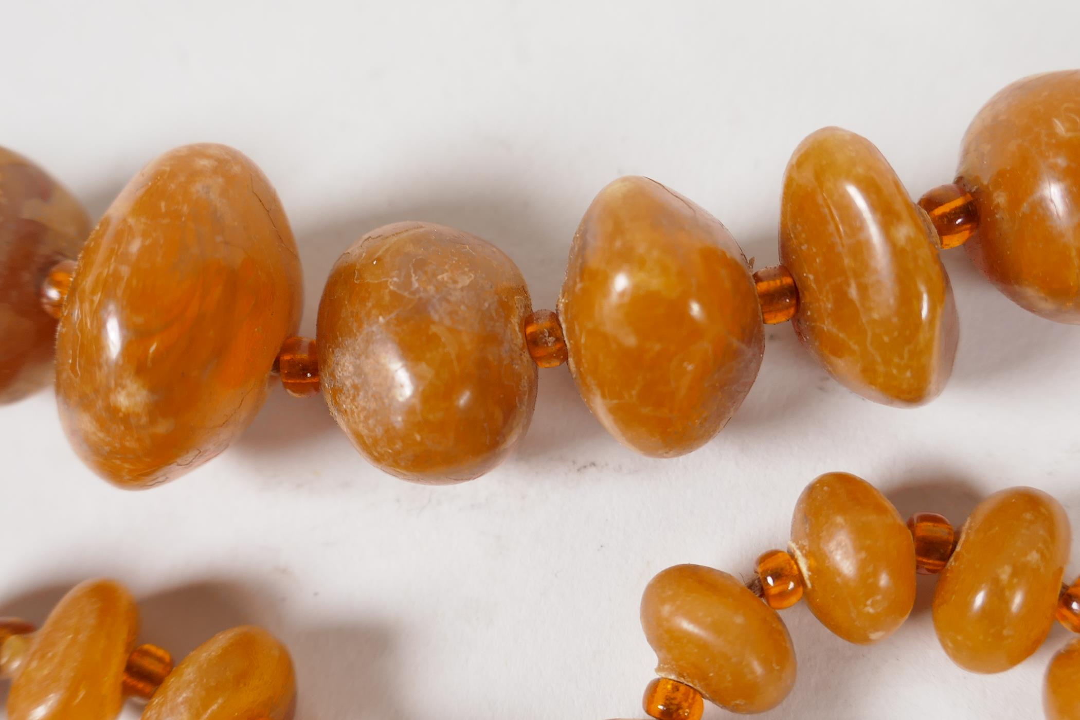 A string of 57 graduated natural amber beads, 20" long, 33g - Image 2 of 4