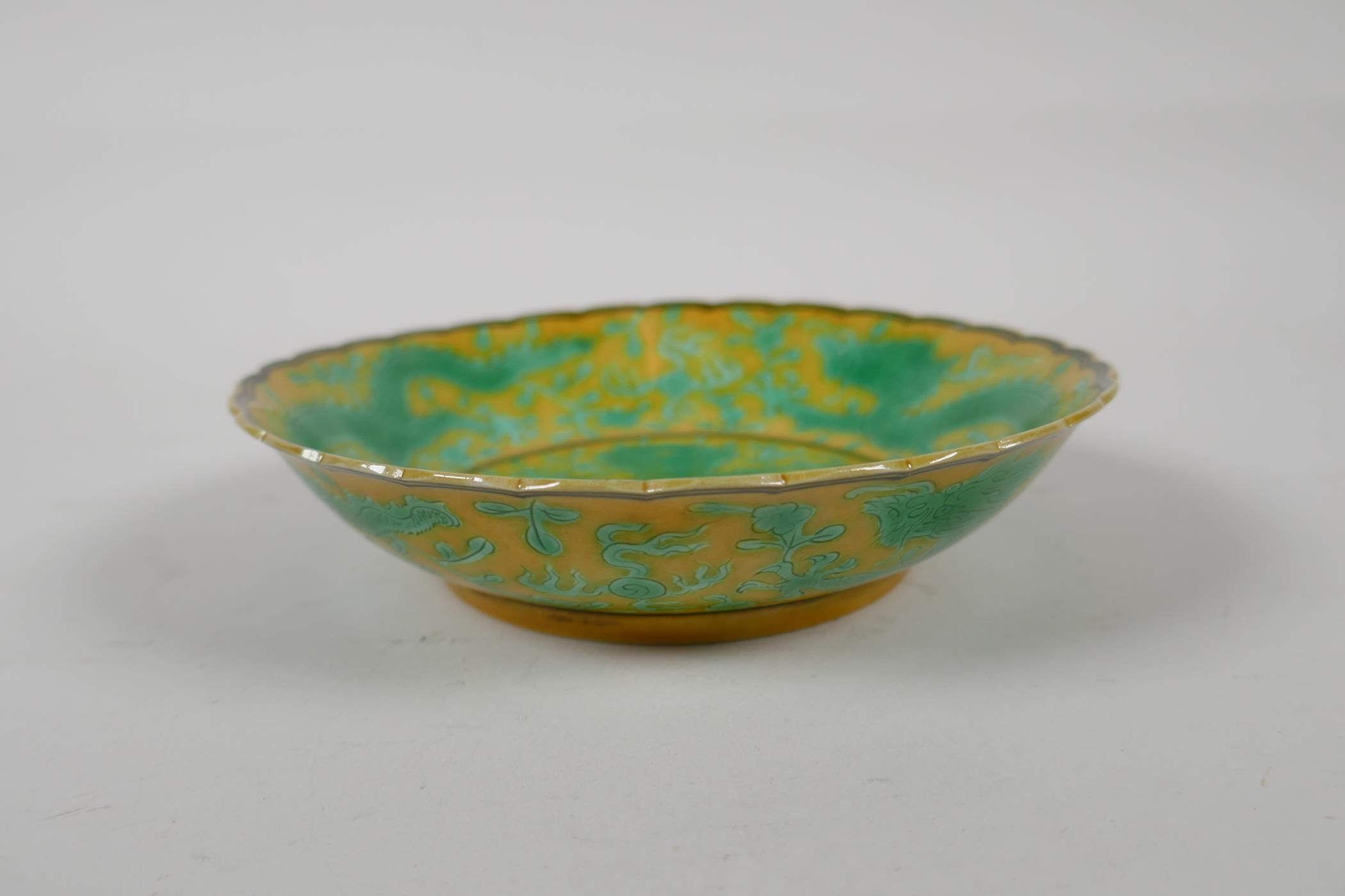 A yellow ground porcelain dish with frilled rim and incised green dragon decoration, Chinese