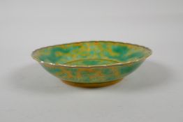 A yellow ground porcelain dish with frilled rim and incised green dragon decoration, Chinese