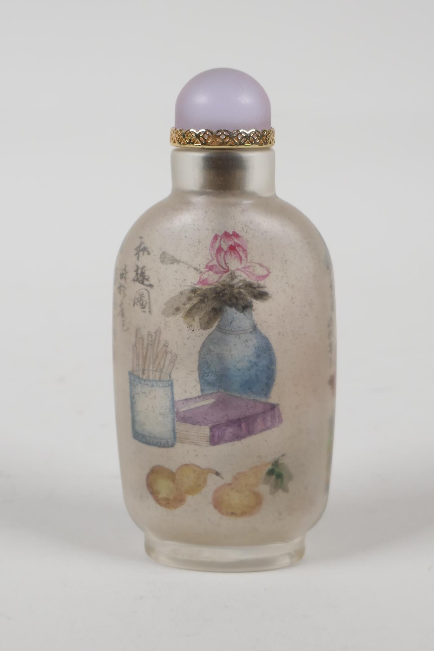 A Chinese reverse decorated glass snuff bottle depicting figures in a river landscape, and scribes - Image 2 of 2