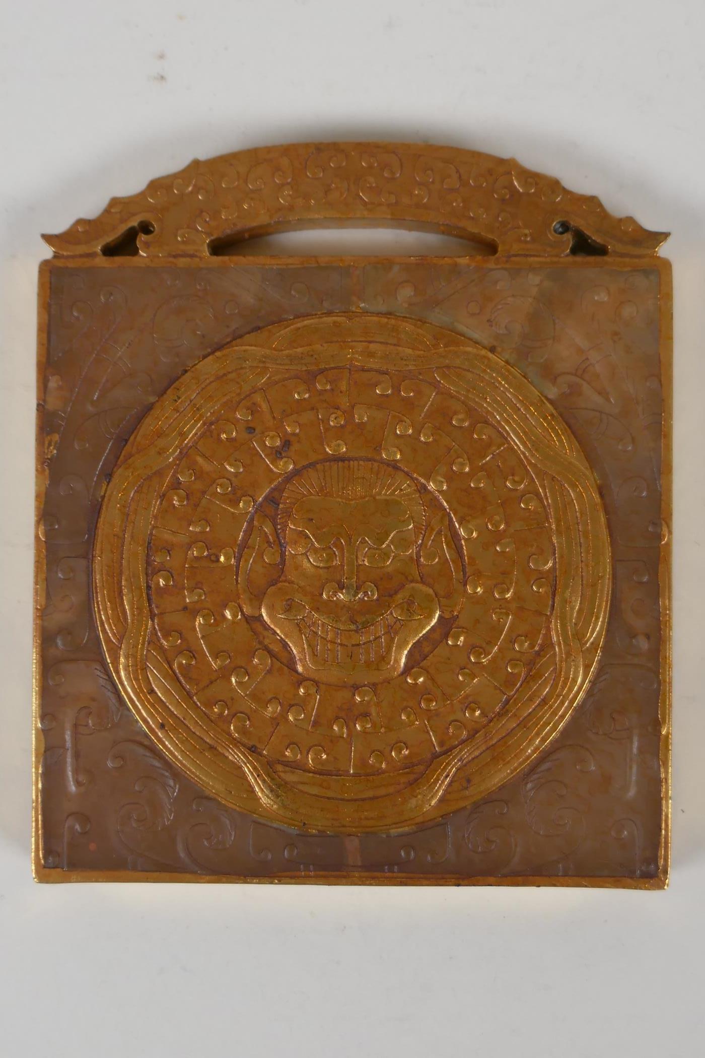 A Chinese carved and gilt hardstone tablet/scroll weight with dragon mask decoration, 3½" x 4½" - Image 2 of 2
