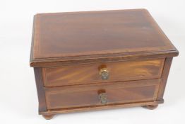 An Edwardian mahogany two drawer jewellery chest, with cross banded decoration to top and drawer