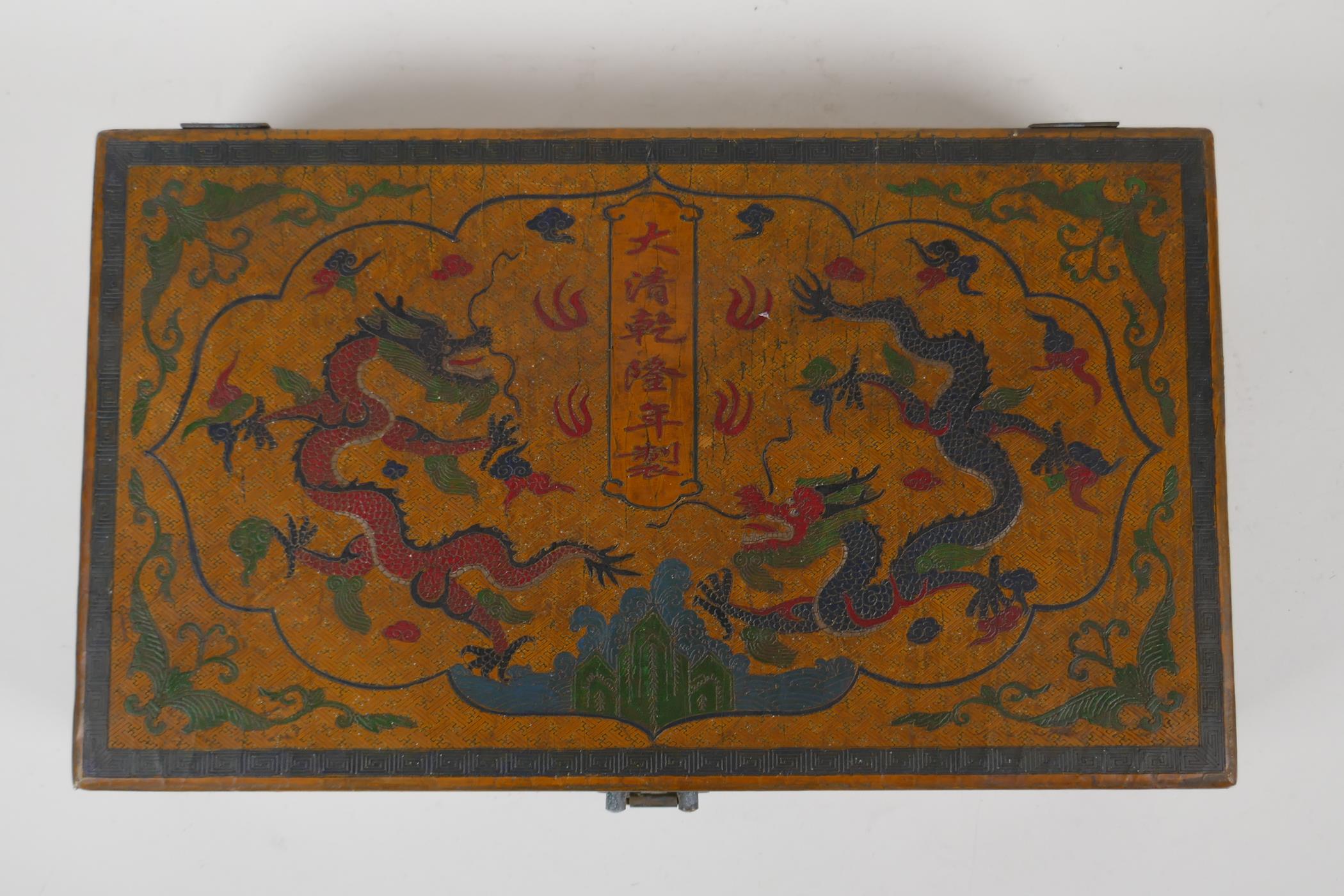 A Chinese ochre ground lacquer box with chased and painted decoration of dragons and character - Image 4 of 4