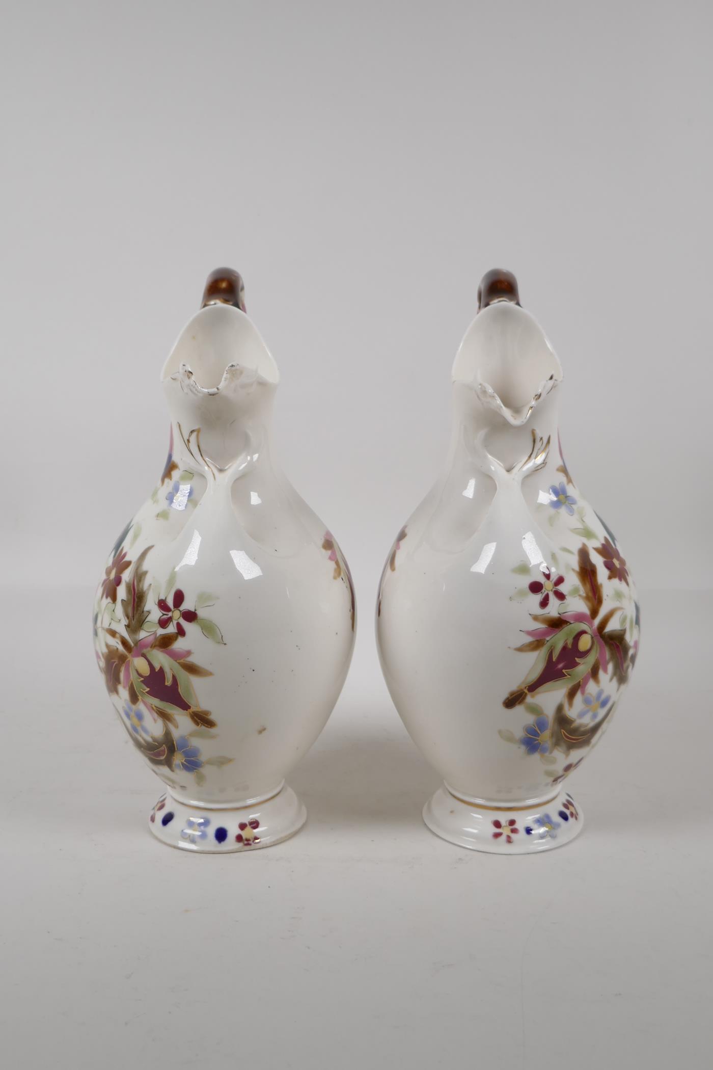 A pair of continental Zsolnay style ewers, decorated with an Iznik design. 11" high - Image 4 of 6