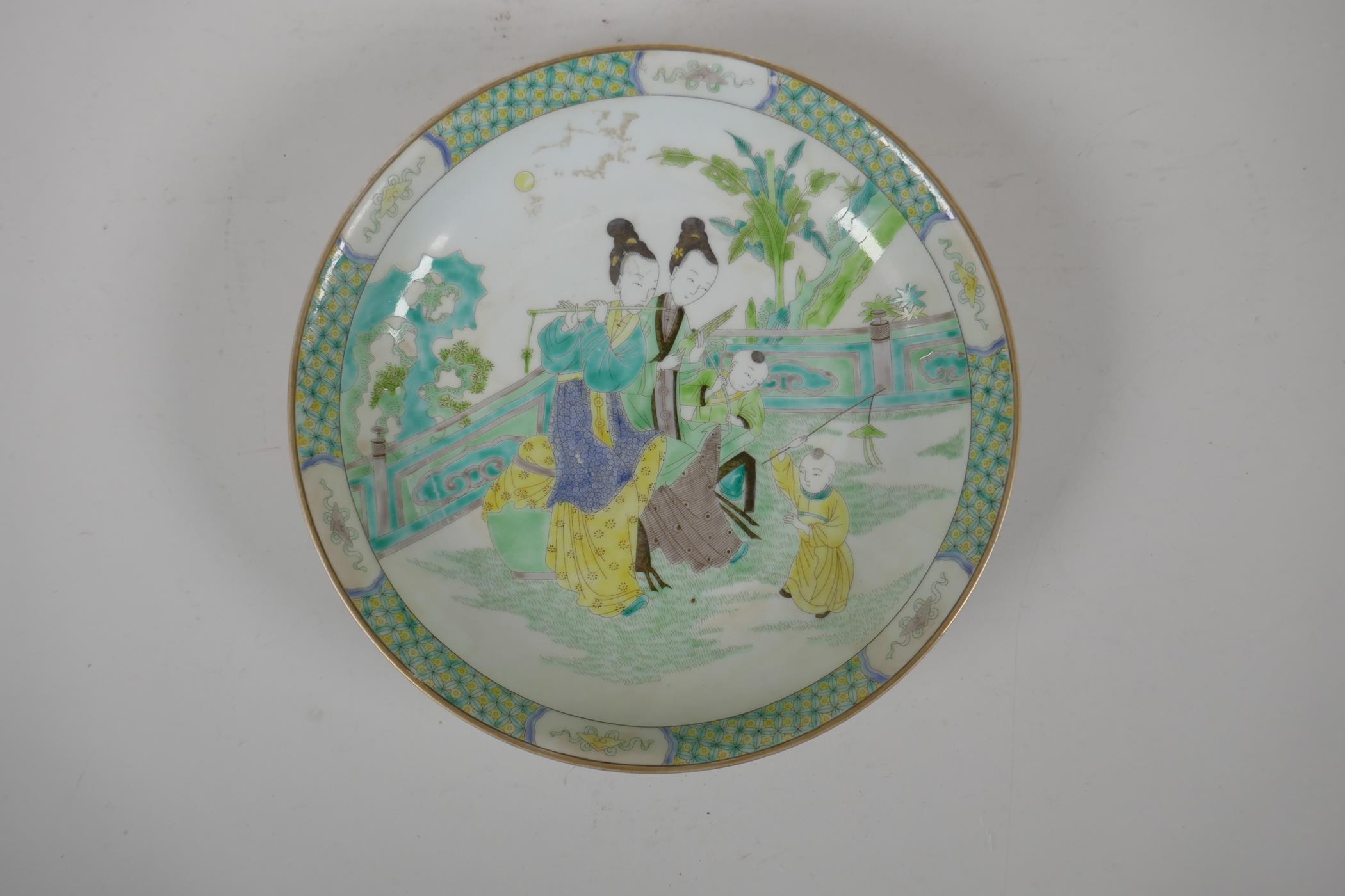 A Chinese famille verte porcelain dish decorated with women and children in a garden, 6 character