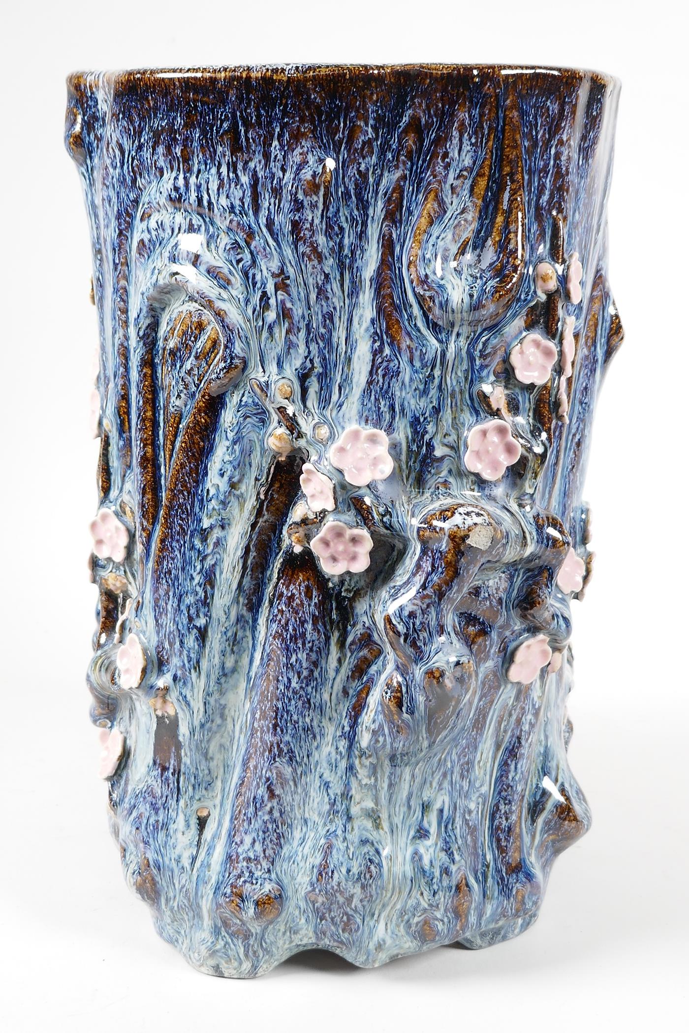 An Oriental stoneware vase, formed as a tree trunk with embossed prunus blossom, on a flambe - Image 3 of 5