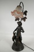 A bronzed composition table lamp cast as a shepherd boy with a lamb, with single glass petal